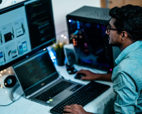man in blue dress shirt using computer